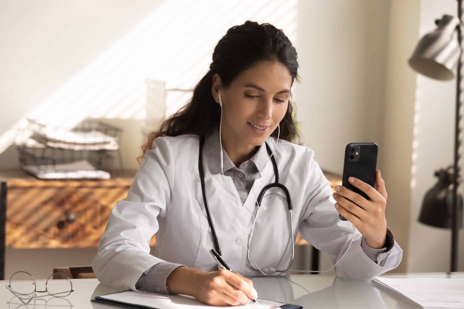 Doctor with phone and HIPAA Compliant VOIP app