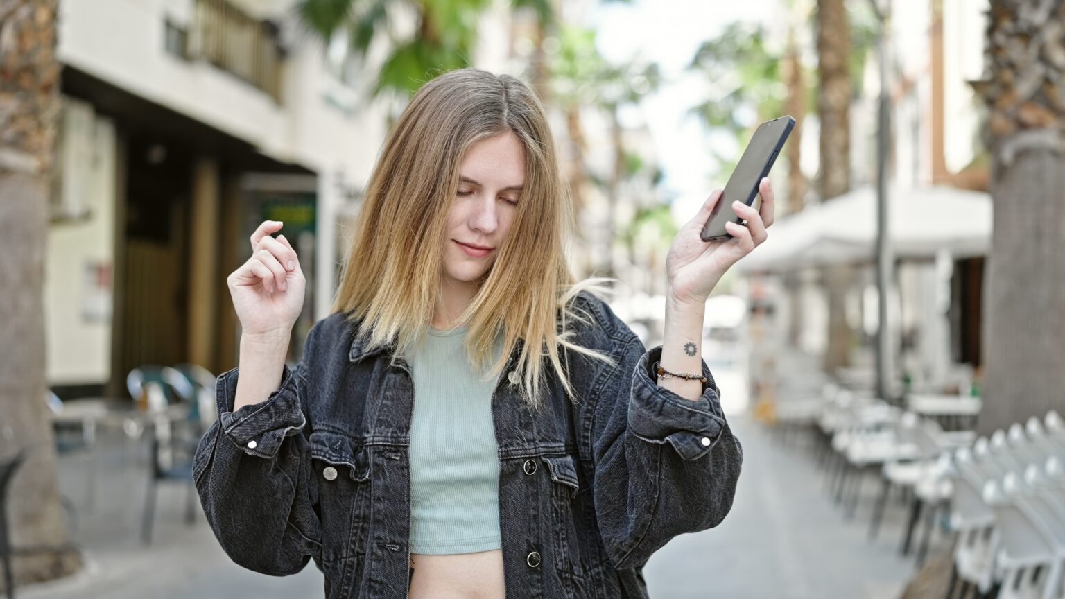 Woman enjoying hold music on mobile phone