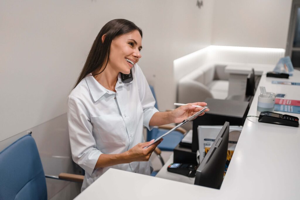 Healthcare practice manager comparing RingRx vs iPlum phone system options for a medical office