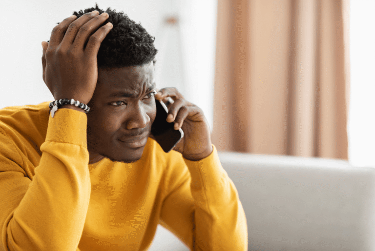 A frustrated patient waiting on hold with their doctor’s office.